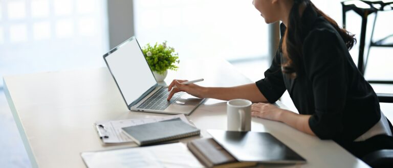 Woman working on a laptop at an office desk